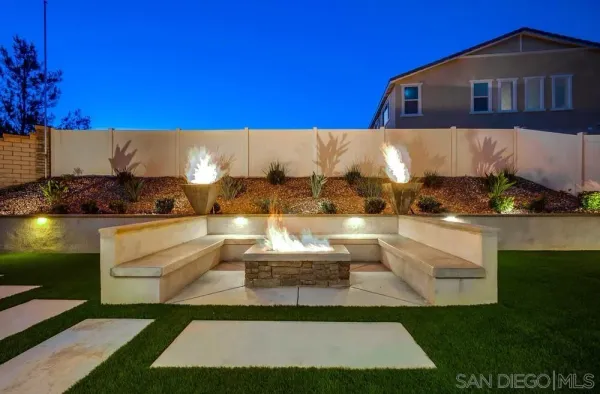a view of an house with swimming pool and sitting area