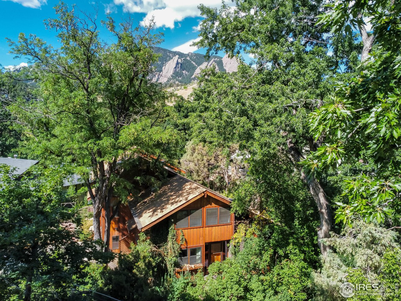 an aerial view of house with yard and outdoor seating