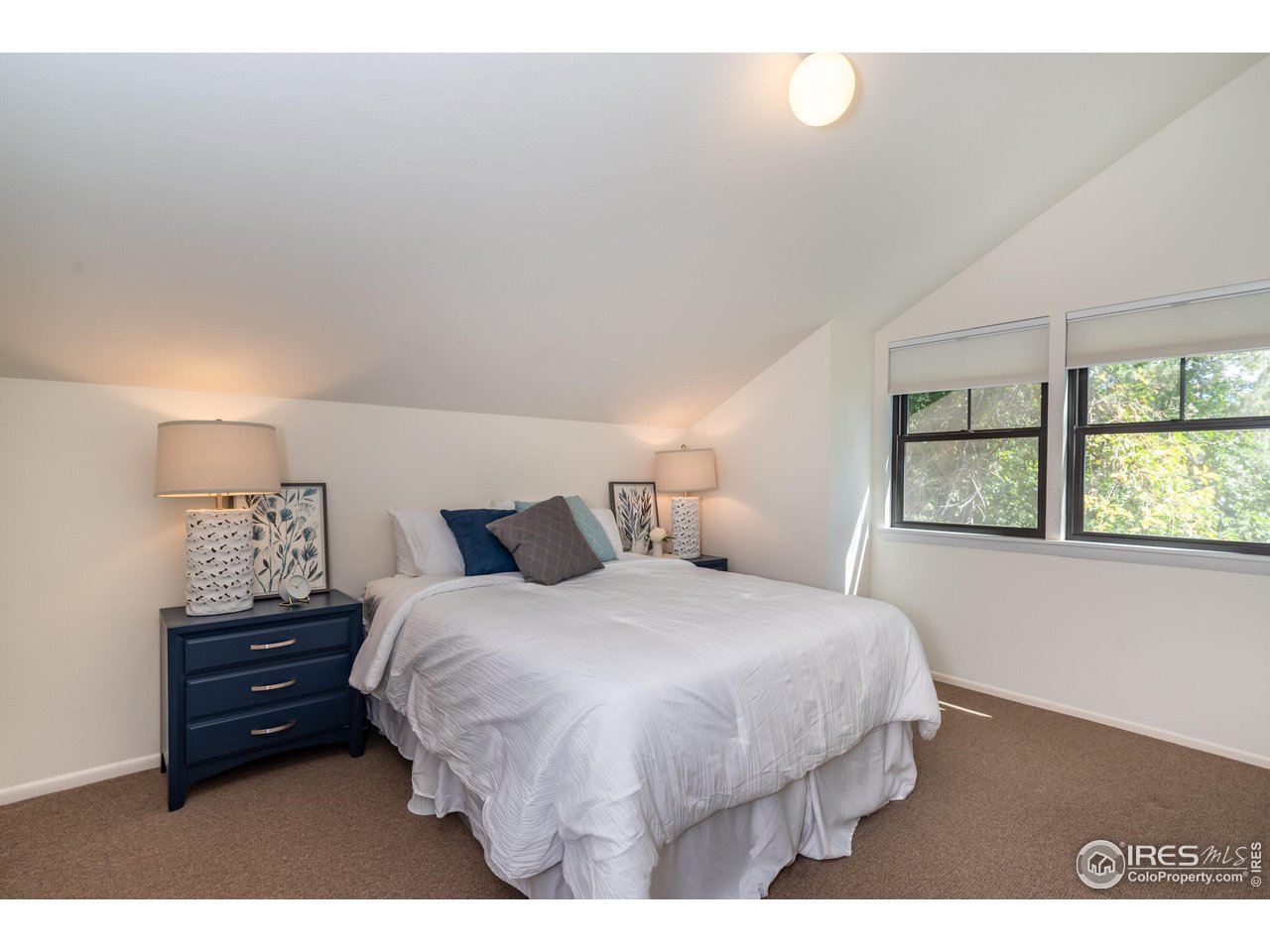 375 16th Street Boulder, CO 80302 - Photo 20 of 30 a bedroom with a bed window and mirror