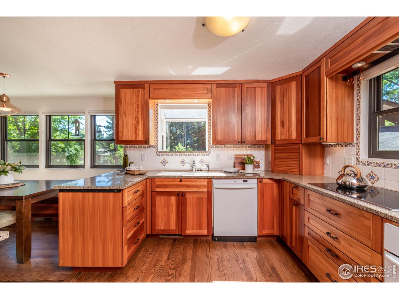 375 16th Street Boulder, CO 80302 - Photo 8 of 30 a kitchen with stainless steel appliances granite countertop a sink a stove and large window