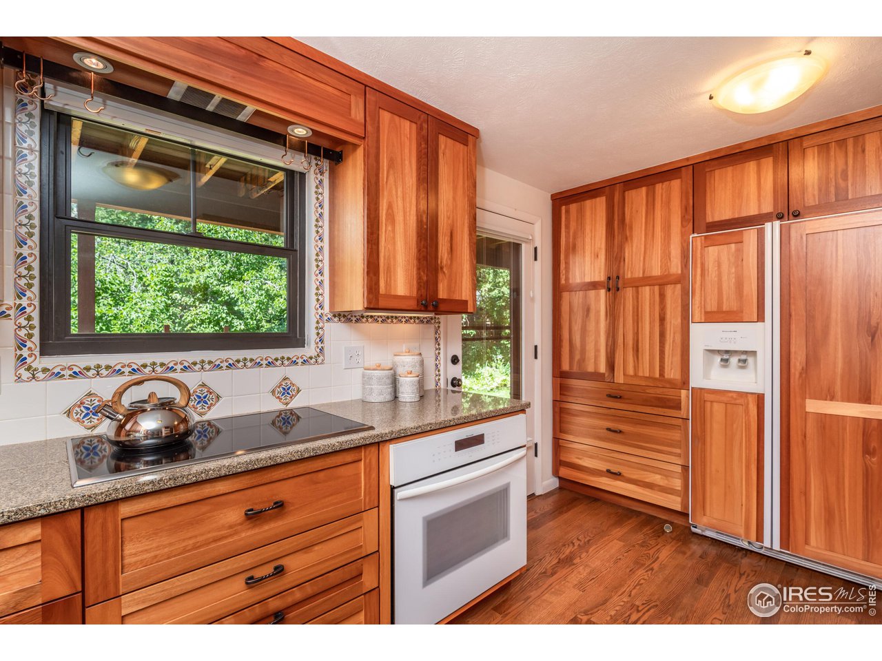 375 16th Street Boulder, CO 80302 - Photo 9 of 30 a kitchen with granite countertop a sink and a window