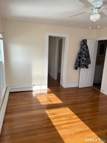 a view of kitchen with refrigerator and wooden floor
