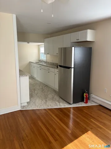 a stove top oven sitting inside of a kitchen