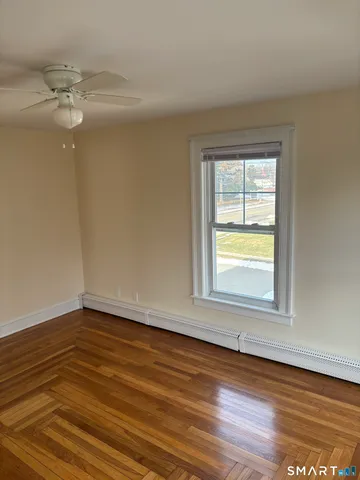 a view of a room with wooden floor