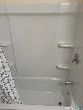 a bathroom with a bathtub and toilet