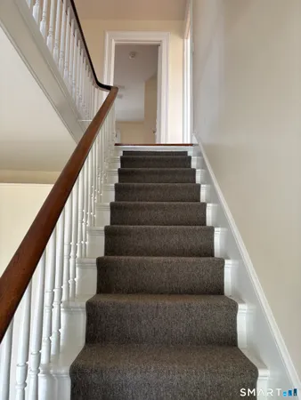 a view of staircase with wooden floor and a window