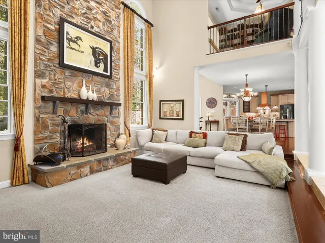 a kitchen with stainless steel appliances granite countertop a sink a stove and a wooden floor