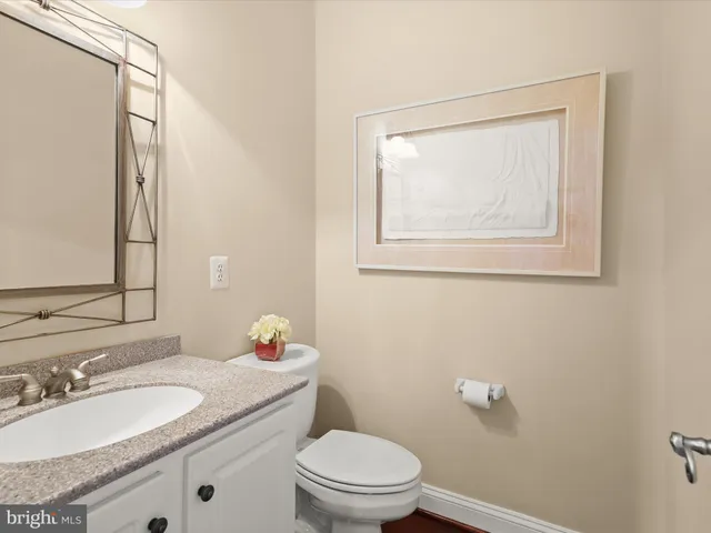 a dining hall with stainless steel appliances kitchen island granite countertop a table chairs in it and a window