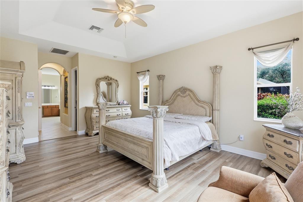 11749 Newberry Grove Loop Riverview, FL 33579 - Photo 21 of 54 a bedroom with a bed and large mirror with window