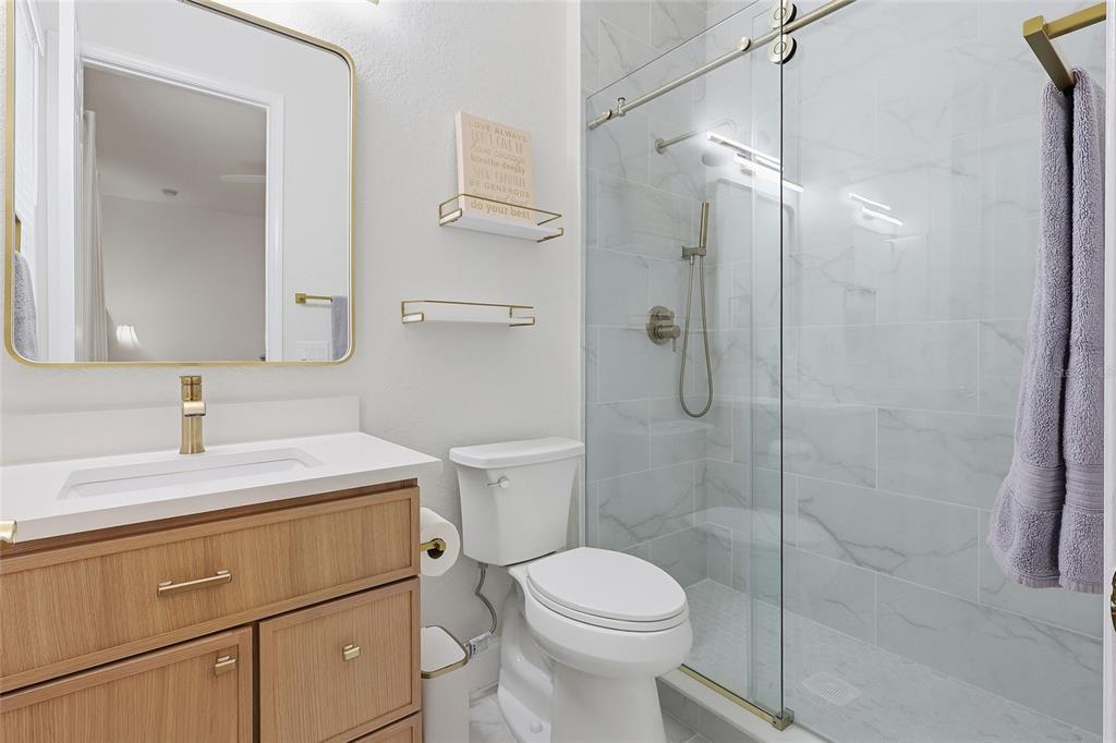 11749 Newberry Grove Loop Riverview, FL 33579 - Photo 27 of 54 a bathroom with a sink toilet vanity and shower