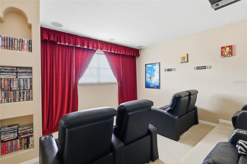 11749 Newberry Grove Loop Riverview, FL 33579 - Photo 30 of 54 a living room with furniture a bookshelf and a window