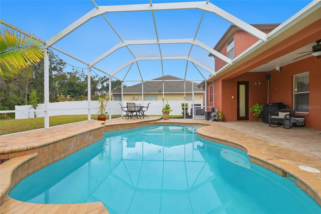 11749 Newberry Grove Loop Riverview, FL 33579 - Photo 3 of 54 a view of a backyard with table and chairs under an umbrella
