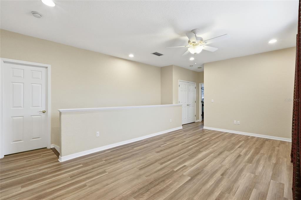 11749 Newberry Grove Loop Riverview, FL 33579 - Photo 33 of 54 a view of an empty room with wooden floor