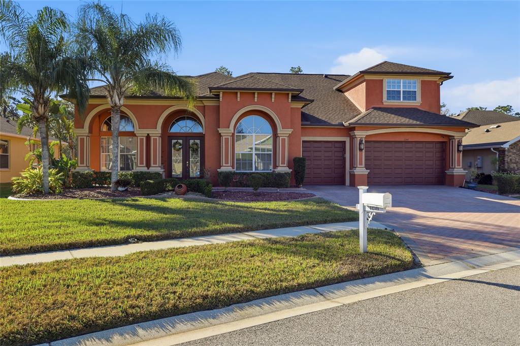 11749 Newberry Grove Loop Riverview, FL 33579 - Photo 54 of 54 a front view of a house with garden