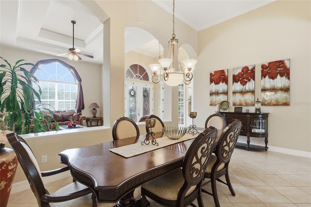 11749 Newberry Grove Loop Riverview, FL 33579 - Photo 9 of 54 a view of a dining room and hall with furniture