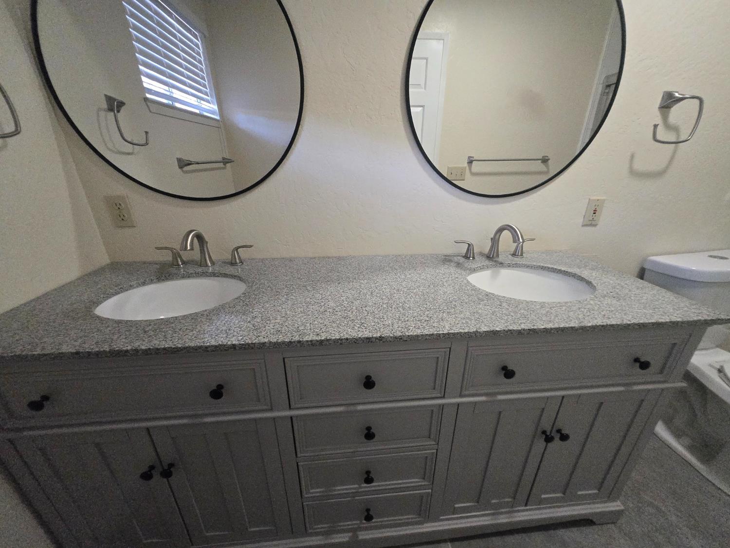 10601 Lime Kiln Road Grass Valley, CA 95949 - Photo 30 of 79 Bathroom features double sinks and two large mirrors.