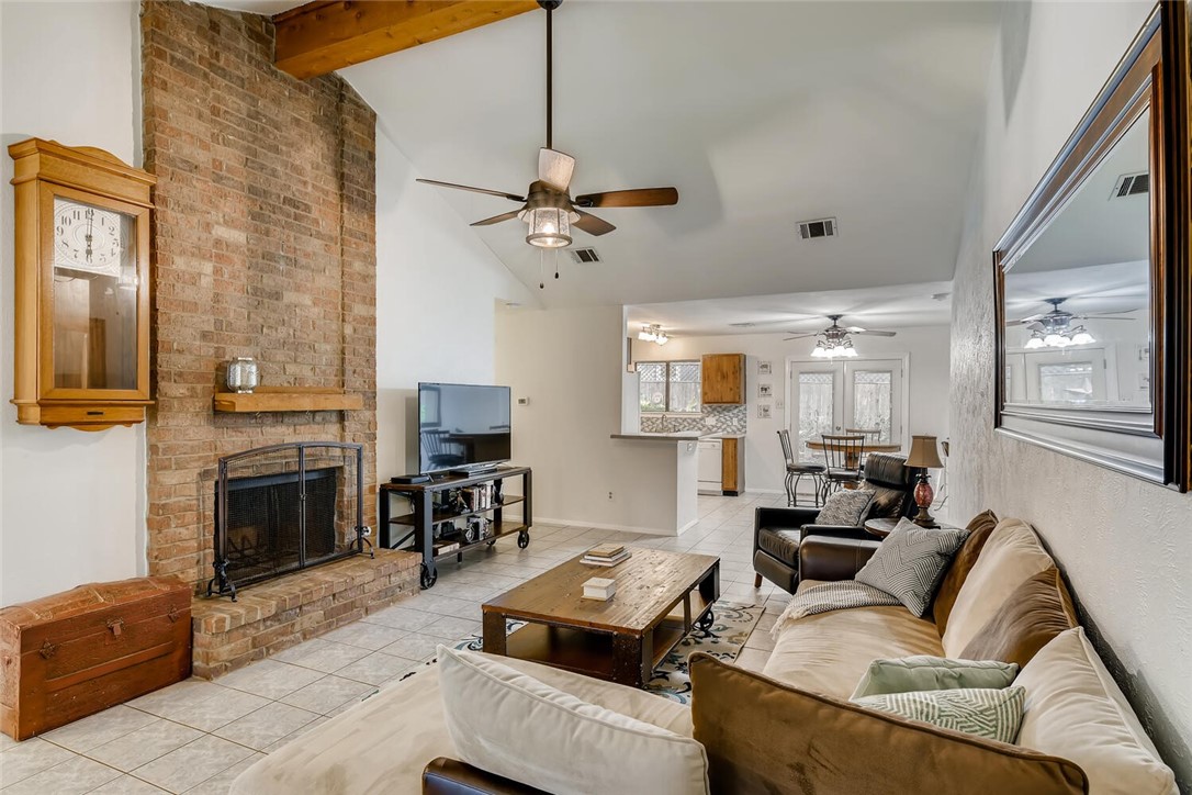 7707 Seminary Ridge Drive Austin, TX 78745 - Photo 1 of 1 a living room with furniture a fireplace and a flat screen tv