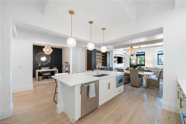 a large kitchen with kitchen island a stove a sink a center island and couches