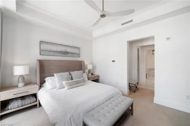 a bedroom with a bed and a night stand