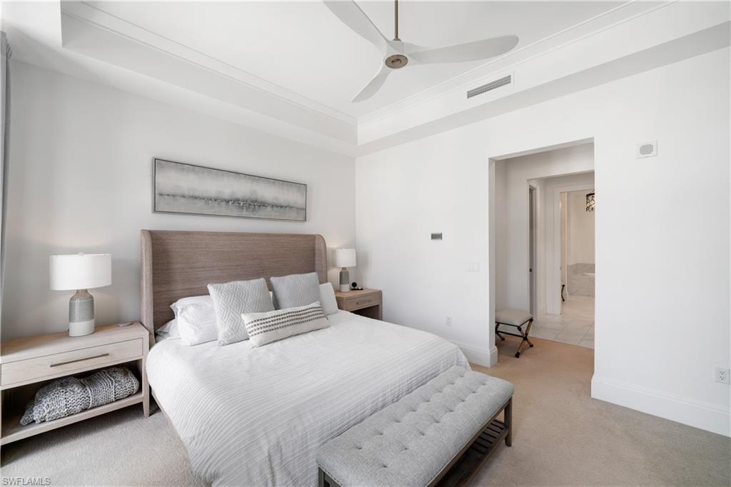 875 6th Avenue South, Unit 304 Naples, FL 34102 - Photo 15 of 40 a bedroom with a bed and a night stand
