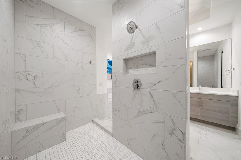 875 6th Avenue South, Unit 304 Naples, FL 34102 - Photo 17 of 40 a bathroom with a bathtub and a shower