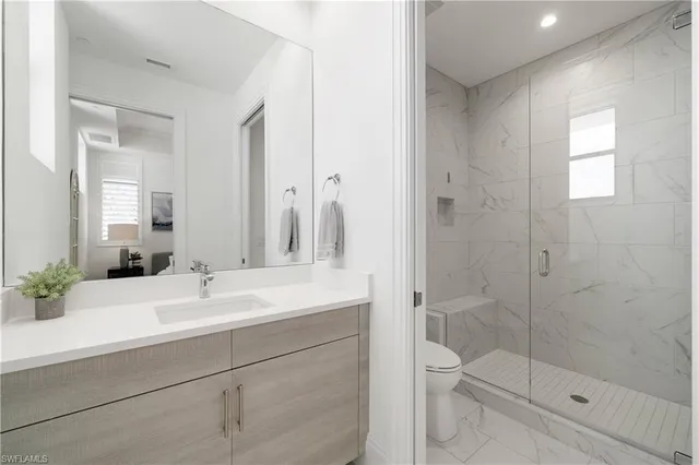 a bathroom with a sink shower and a mirror