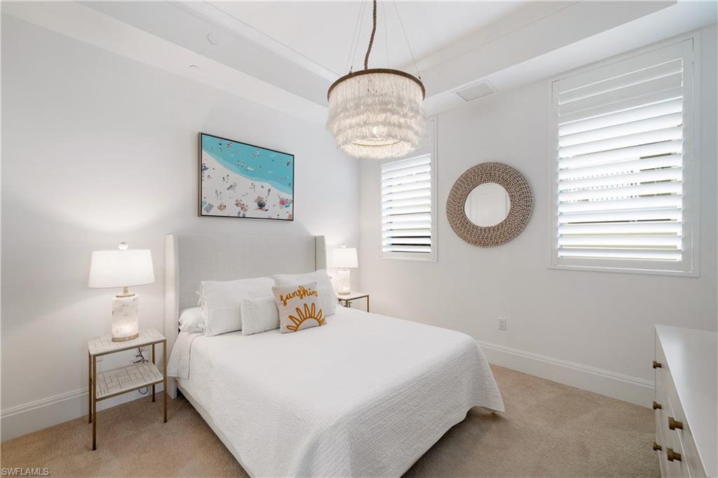 875 6th Avenue South, Unit 304 Naples, FL 34102 - Photo 21 of 40 a bedroom with a bed and window
