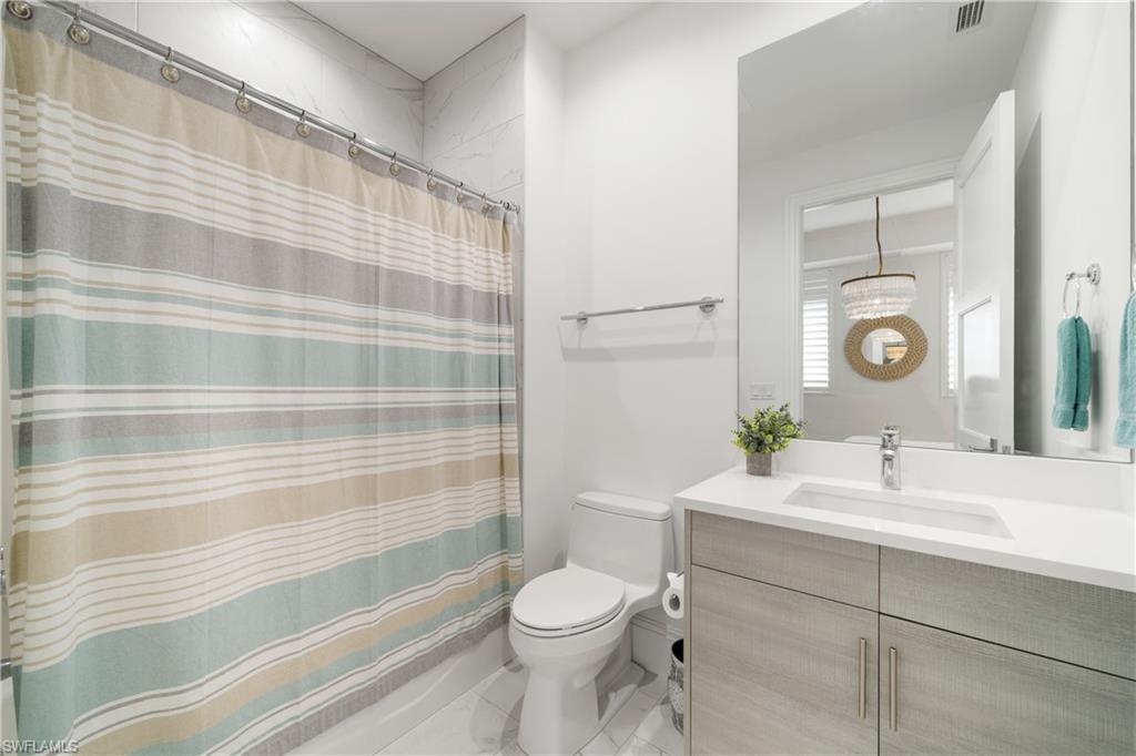 875 6th Avenue South, Unit 304 Naples, FL 34102 - Photo 23 of 40 a bathroom with a sink a toilet and shower