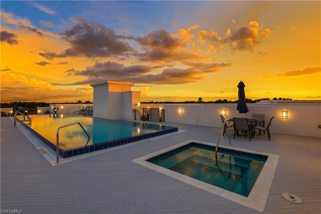 875 6th Avenue South, Unit 304 Naples, FL 34102 - Photo 27 of 40 a view of a swimming pool with an outdoor seating and a terrace view