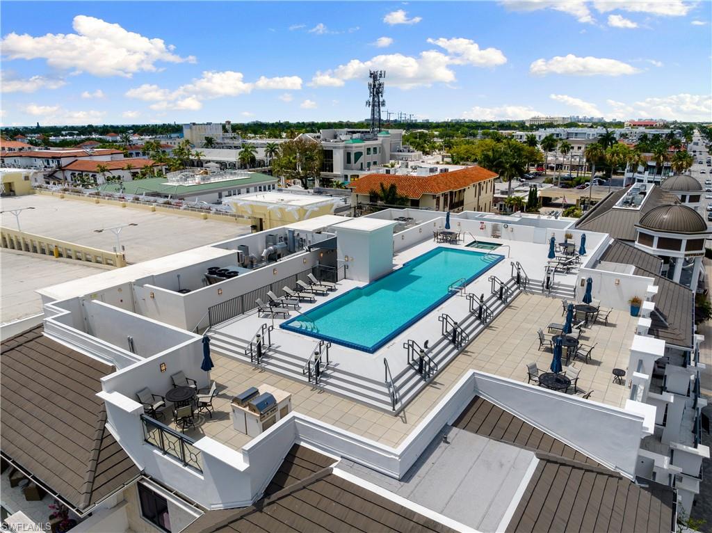 875 6th Avenue South, Unit 304 Naples, FL 34102 - Photo 30 of 40 a view of a terrace with lawn chairs