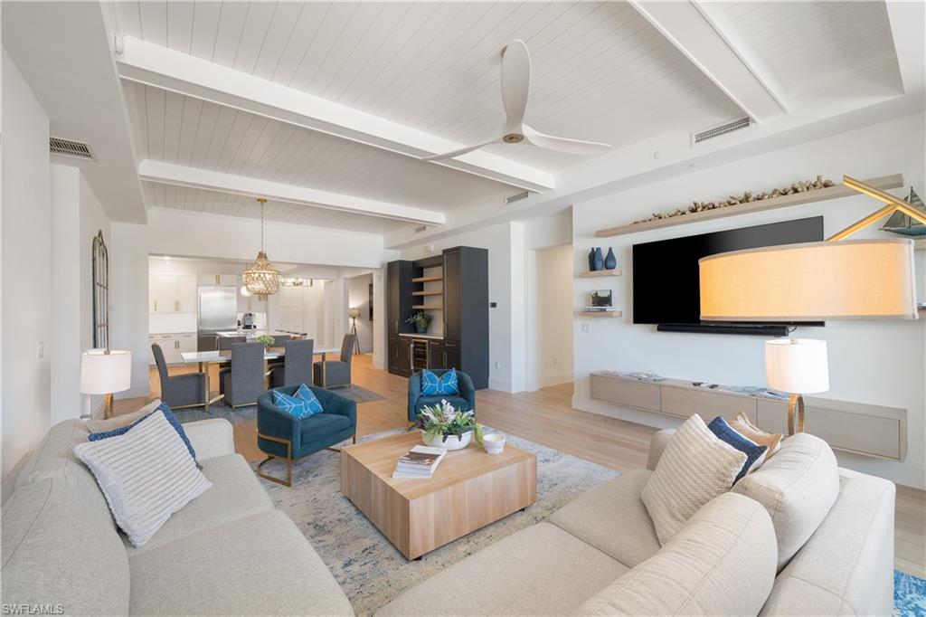 875 6th Avenue South, Unit 304 Naples, FL 34102 - Photo 5 of 40 a living room with furniture and a flat screen tv