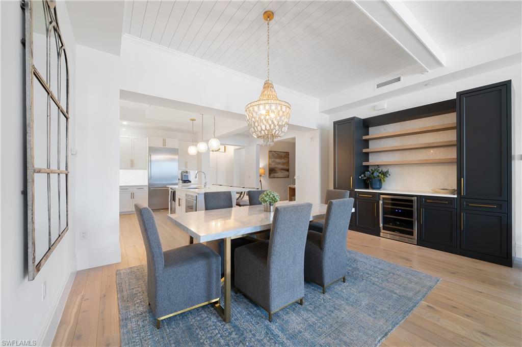 875 6th Avenue South, Unit 304 Naples, FL 34102 - Photo 10 of 40 a dining room with furniture a chandelier and window