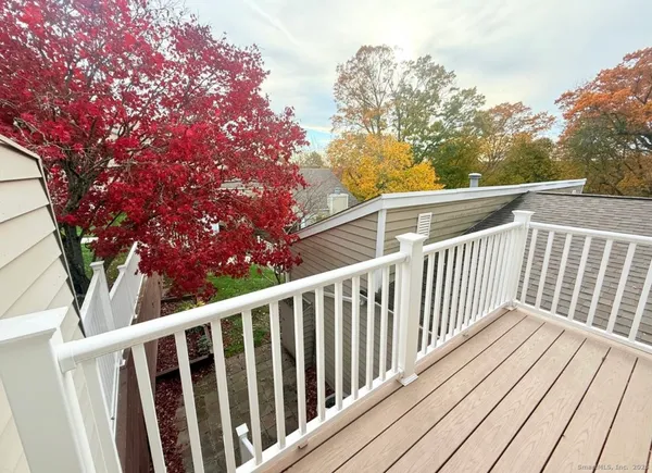 a view of balcony with wooden floor and fence