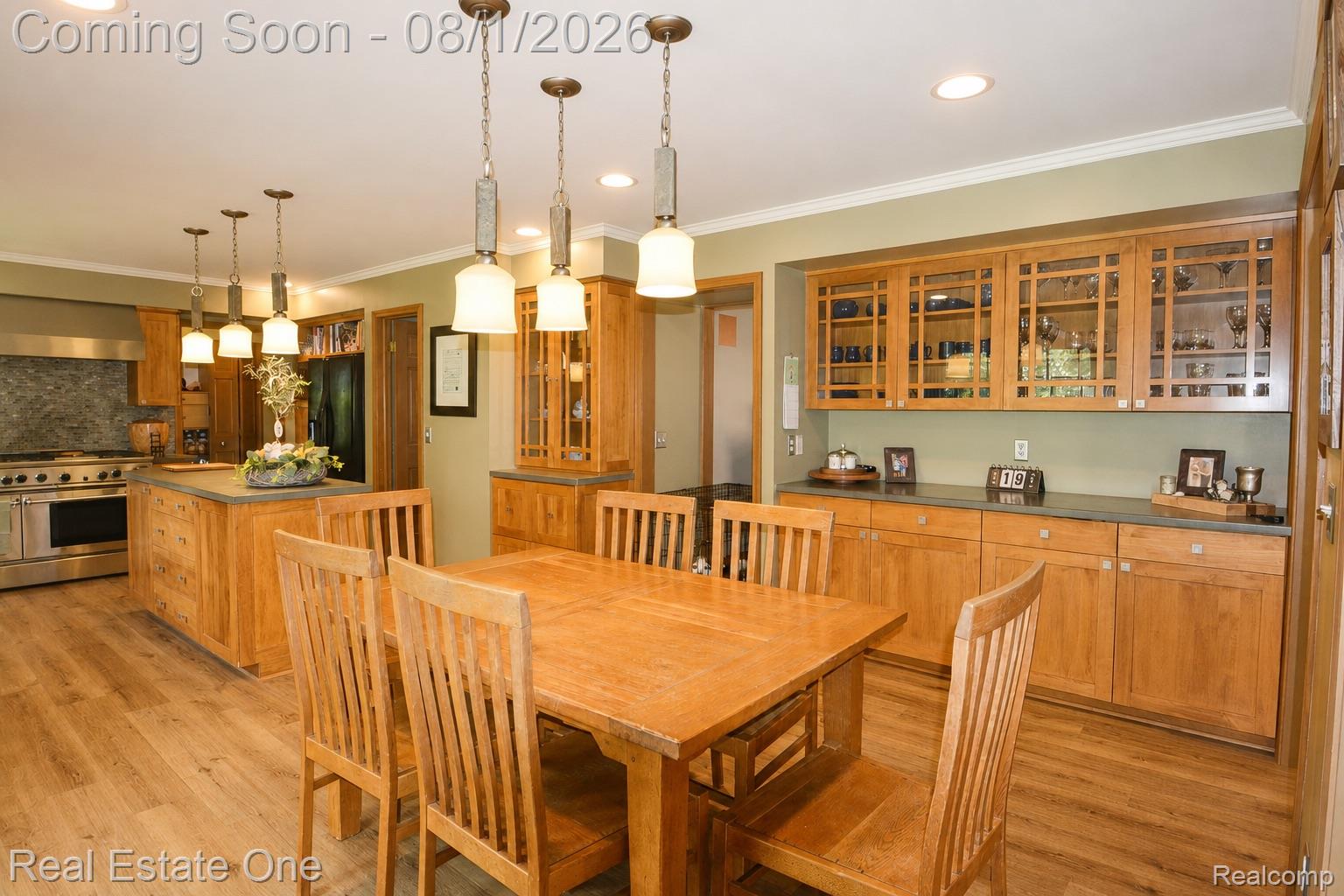 1370 Springwood Lane Rochester, MI 48309 - Photo 7 of 37 Open-concept kitchen and dining area featuring wood-finish flooring, recessed lighting, and crown molding