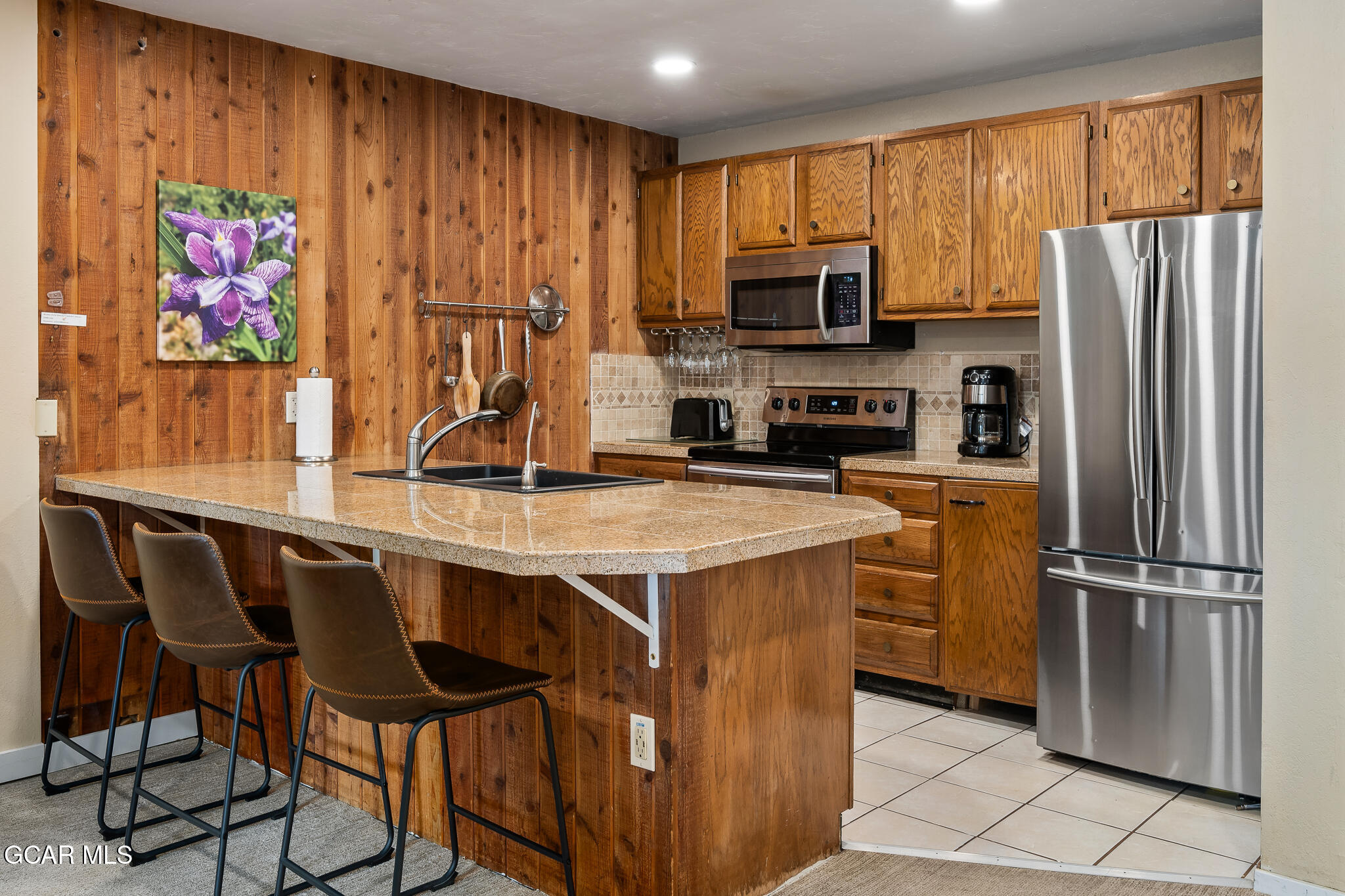 490 Kings Crossing Road, Unit 611 Winter Park, CO 80482 - Photo 15 of 39 a kitchen with stainless steel appliances granite countertop a refrigerator and a stove top oven