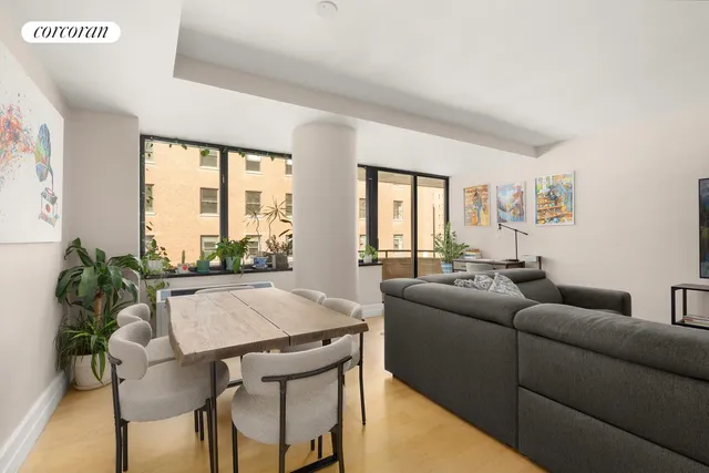 a living room with furniture and a floor to ceiling window