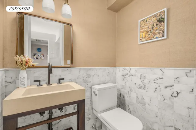 a bedroom with a white bed and flat screen tv