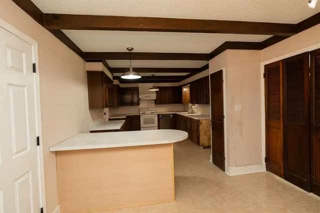 a view of kitchen and refrigerator