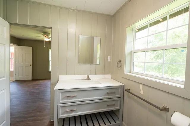 a bathroom with a sink a toilet and a mirror