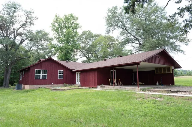 a front view of a house with yard and green space