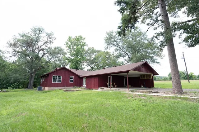 a house view with a sitting space and garden