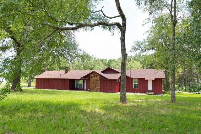 a front view of a house with a garden and deck