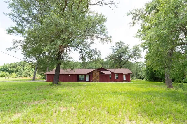 a house view with swimming pool in front of it