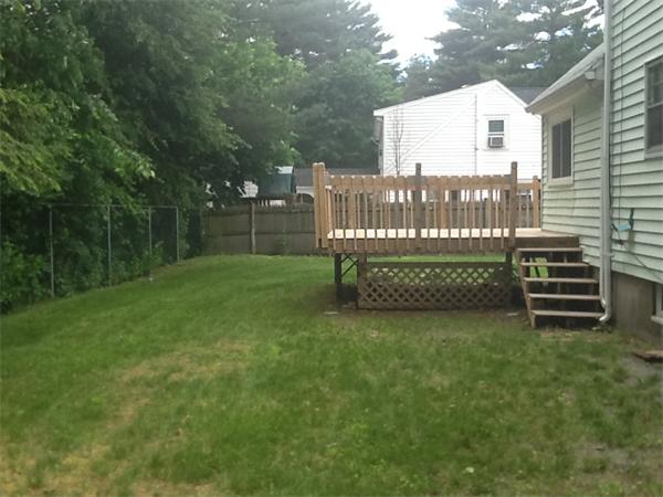 19 Barrows Road Reading, MA 01867 - Photo 5 of 21 a view of a chair and table in the backyard