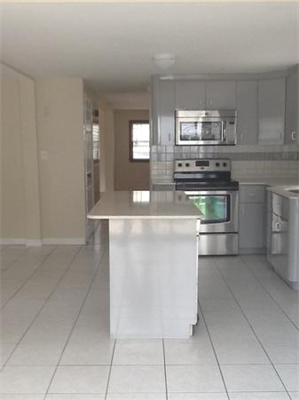 19 Barrows Road Reading, MA 01867 - Photo 8 of 21 a kitchen with stainless steel appliances granite countertop a sink and a stove
