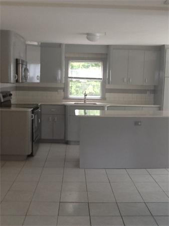 19 Barrows Road Reading, MA 01867 - Photo 9 of 21 a kitchen with a sink a window and cabinets