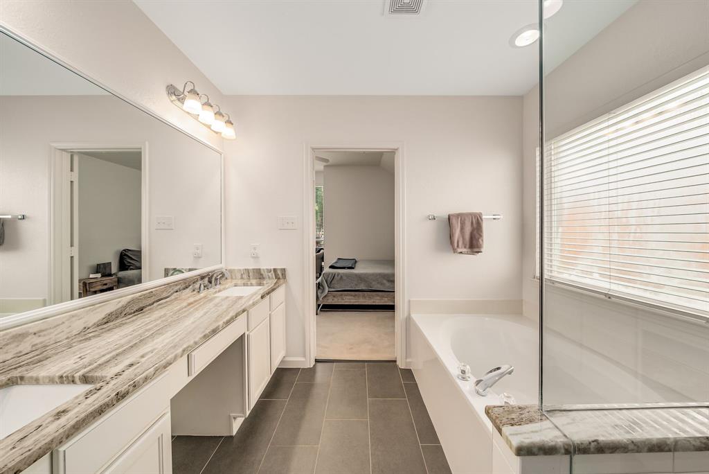 2524 Windgate Drive Frisco, TX 75033 - Photo 17 of 38 a spacious bathroom with a tub sink and mirror