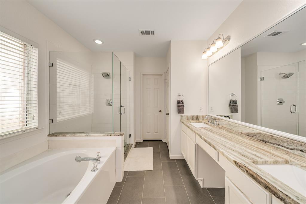 2524 Windgate Drive Frisco, TX 75033 - Photo 18 of 38 a spacious bathroom with a tub sink shower and a mirror