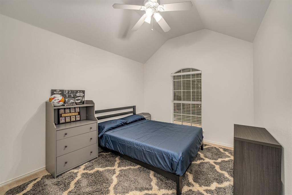 2524 Windgate Drive Frisco, TX 75033 - Photo 25 of 38 a bedroom with furniture and a chandelier