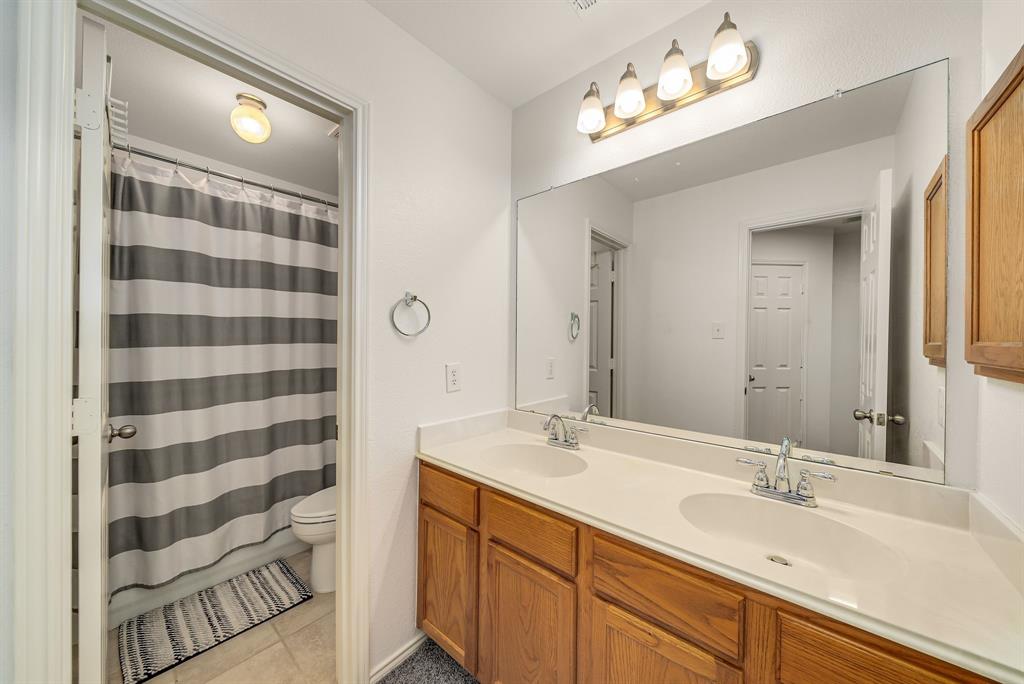 2524 Windgate Drive Frisco, TX 75033 - Photo 26 of 38 a bathroom with a sink and a mirror